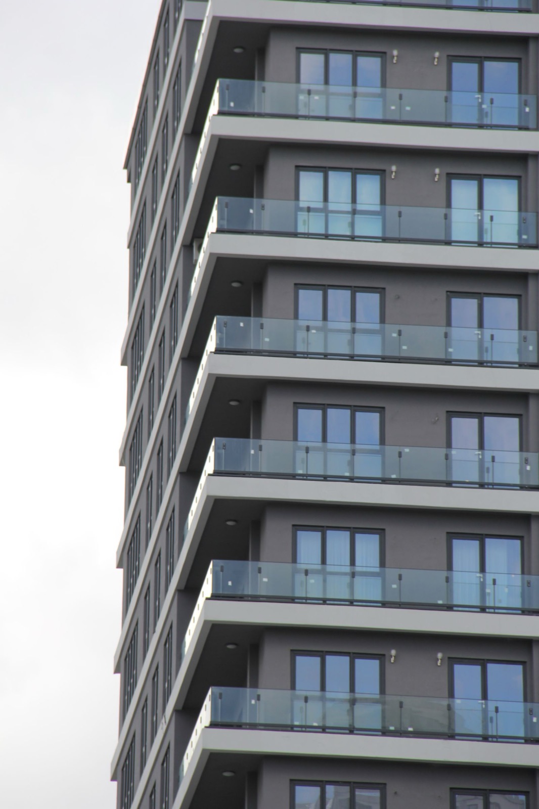 Glass balcony railings on a strata apartment building